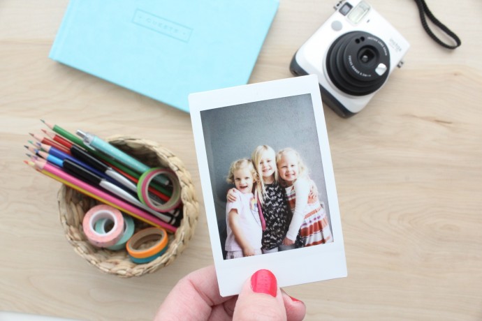 share an instant photo with friends using an Instax camera
